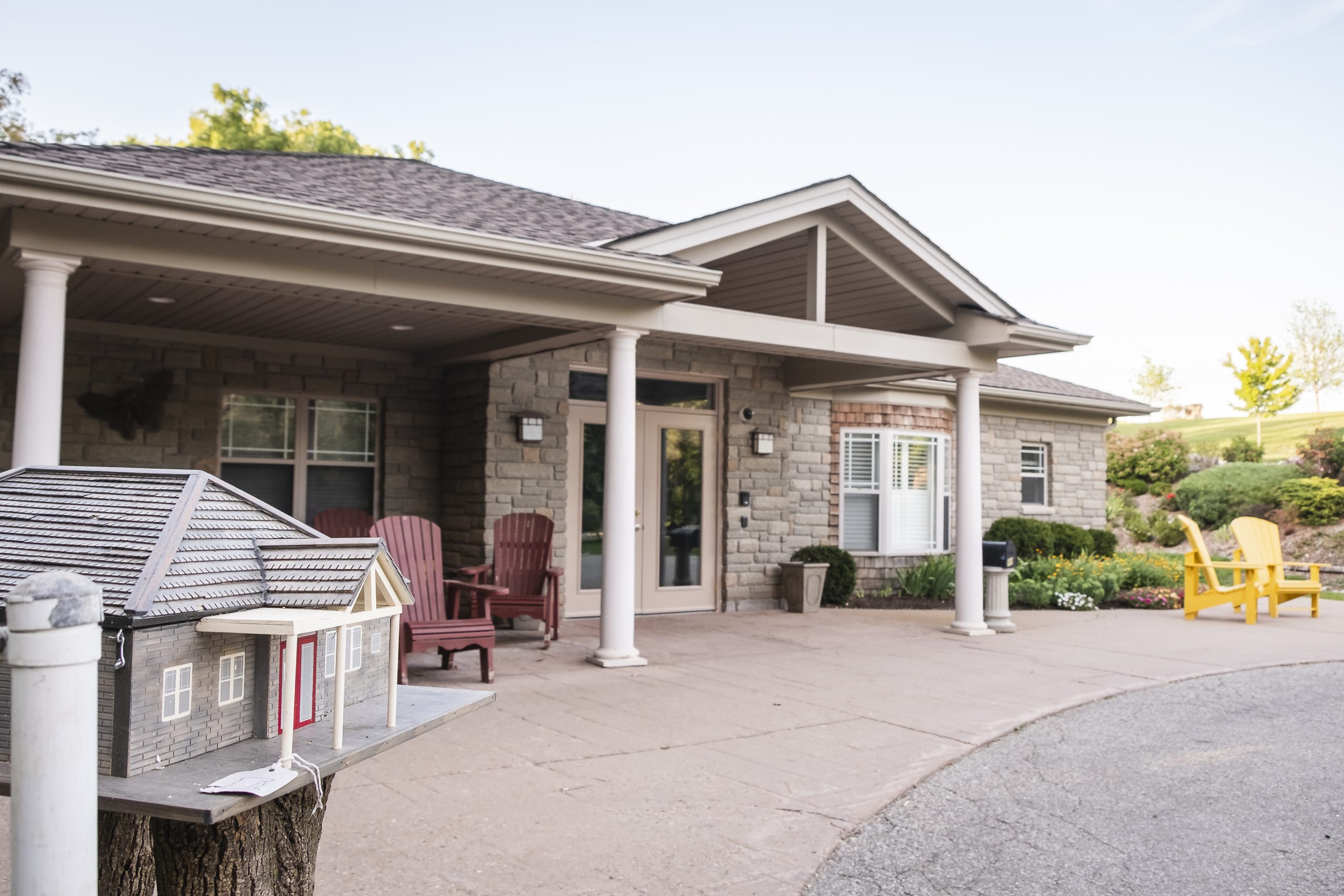 Guri dhagax ah oo balbado hore leh, kuraas casaan iyo jaalle ah, iyo sanduuq boosto oo u eg guri ku yaal xagga hore.