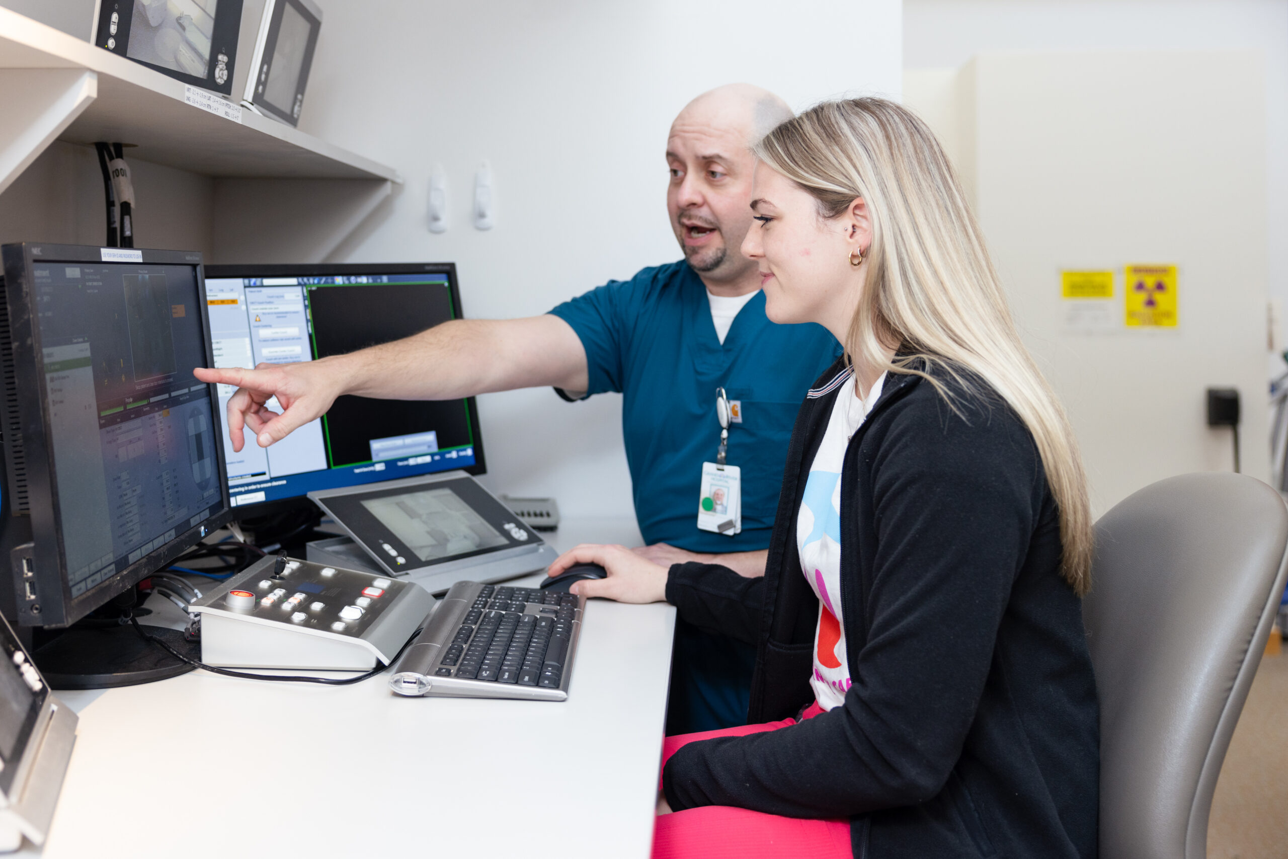Two Radiation Therapists planning a treatment for their patient.